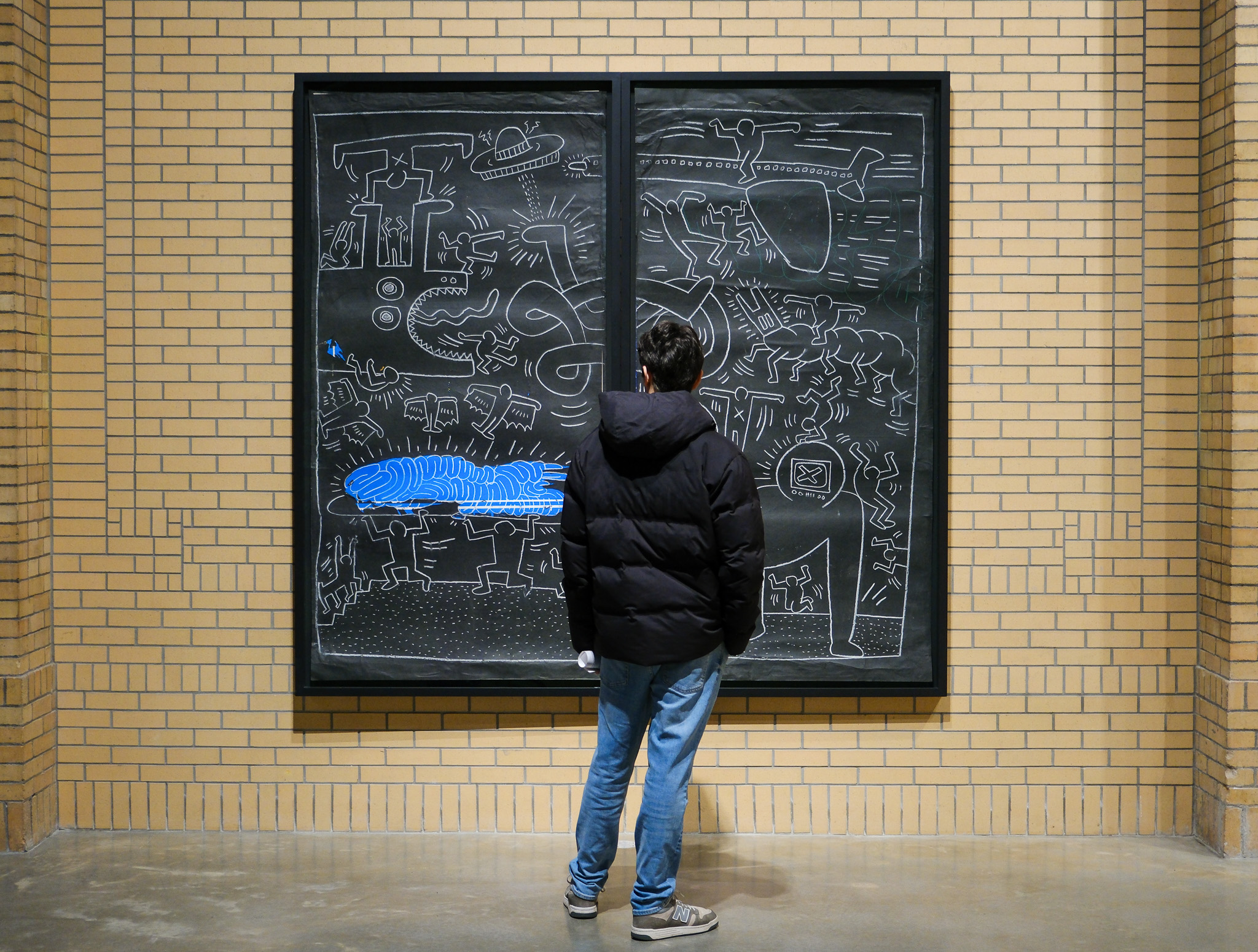 A guest considers an 1984 subway chalk drawing at the Brant Foundation. Photo by Jamie Lubekin